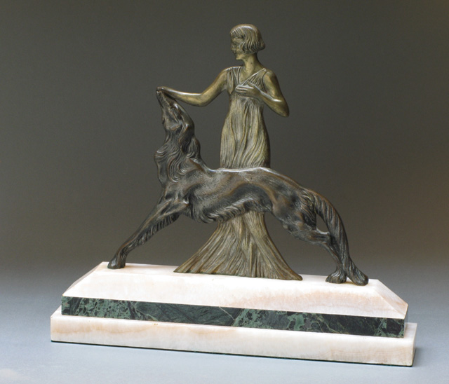 Appraisal: TWO DIMENSIONAL BRONZE SCULPTURE of a young woman standing in