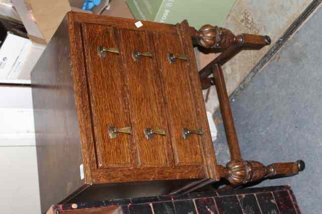 Appraisal: AN OAK THREE DRAWER CANTEEN CASE on stand containing a