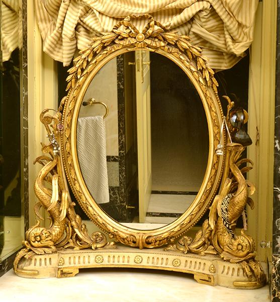 Appraisal: OVAL PAINTED AND GILDED TOILET MIRROR SUPPORTED BY FISH