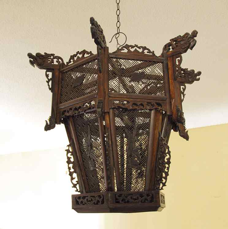 Appraisal: CHINESE RETICULATED WOOD HANGING LANTERN Candle burning with figural dragons