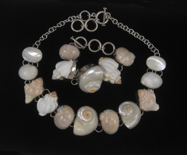 Appraisal: SHELL NECKLACE AND BRACELET mounted in white metal with toggle