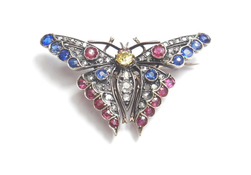 Appraisal: A diamond sapphire and vary coloured gem set brooch designed