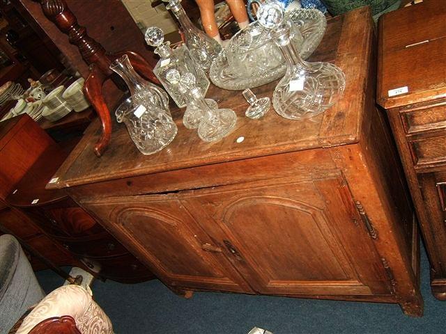 Appraisal: A Continental oak side cabinet with two panelled doors standing