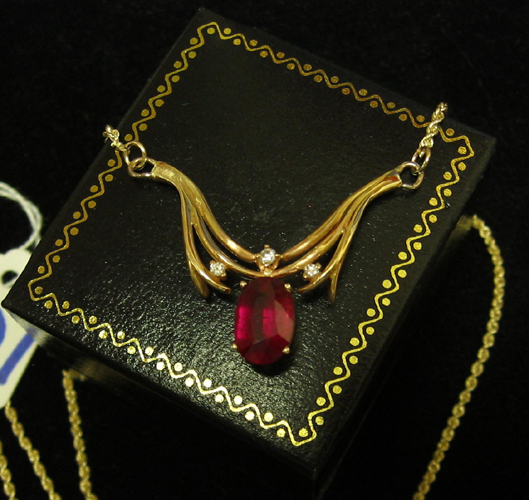 Appraisal: RUBY DIAMOND AND FOURTEEN KARAT GOLD PENDANT NECKLACE The V-shaped