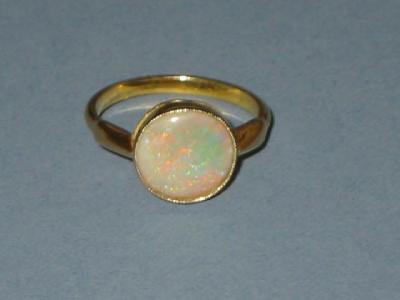 Appraisal: AN OPAL RING comprising round polished opal collet set on