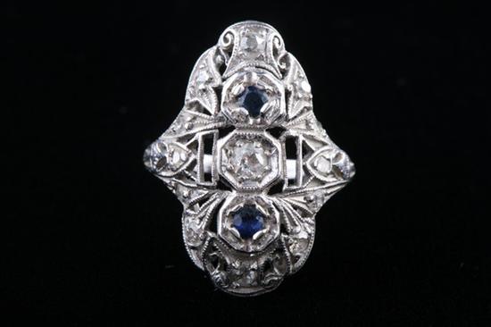 Appraisal: EDWARDIAN WHITE GOLD DIAMOND AND SAPPHIRE OPENWORK RING Shaped oblong