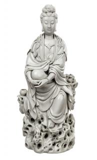 Appraisal: A BLANC-DE-CHINE FIGURE OF GUANYIN ON A ROCKa large figure