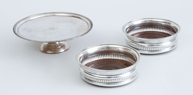 Appraisal: PAIR OF ENGLISH SILVER-PLATED COASTERS AND A SILVER-PLATED CRESTED AND