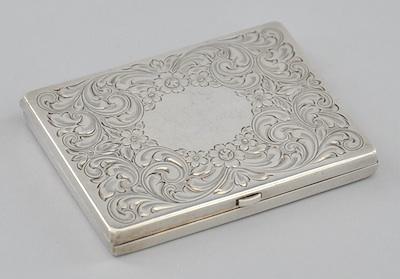 Appraisal: A Sterling Silver Compact With an engraved floral decoration on