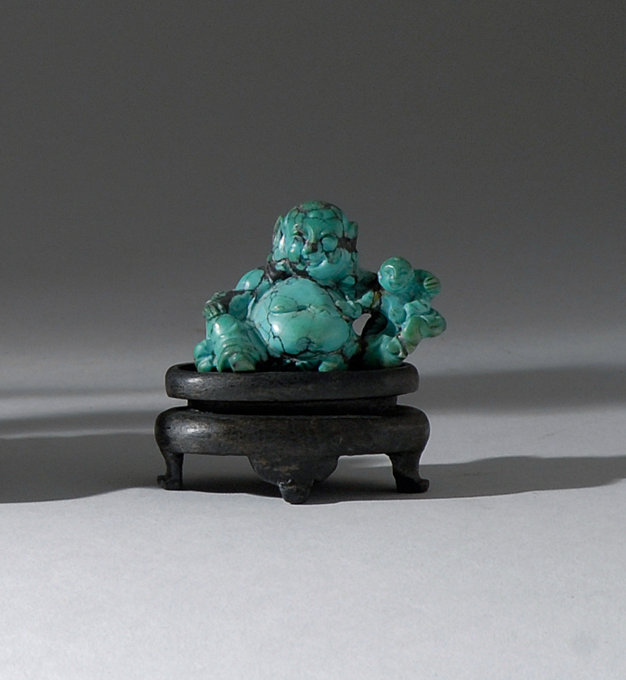 Appraisal: TURQUOISE FIGURE Circa Depicting Joss with two children Length cm