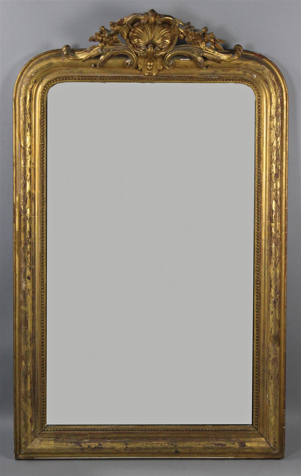 Appraisal: ROCOCO STYLE GILTWOOD WALL MIRROR having a carved pediment with