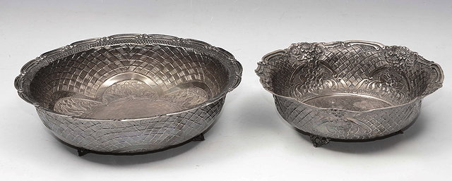 Appraisal: A GREEK WHITE METAL BOWL repouss decorated within a basket