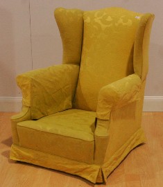 Appraisal: A fabric upholstered George II style wingback armchair