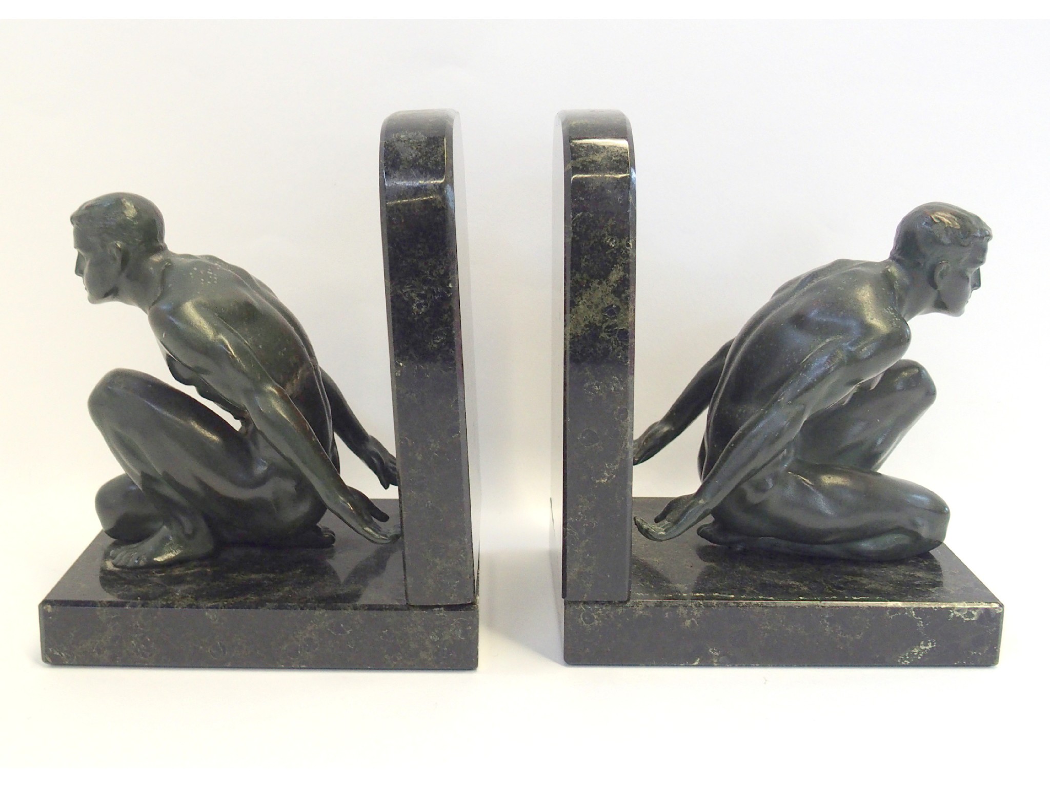 Appraisal: Pair of black marble bookends modelled with crouching muscular men