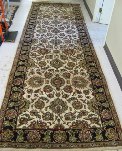 Appraisal: WIDE ORIENTAL HALL CARPET Indo-Kashan overall floral decoration on ivory