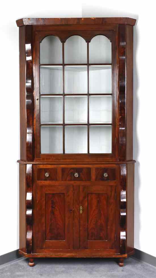 Appraisal: An American Empire Mahogany Veneered Corner Cabinet having a flared