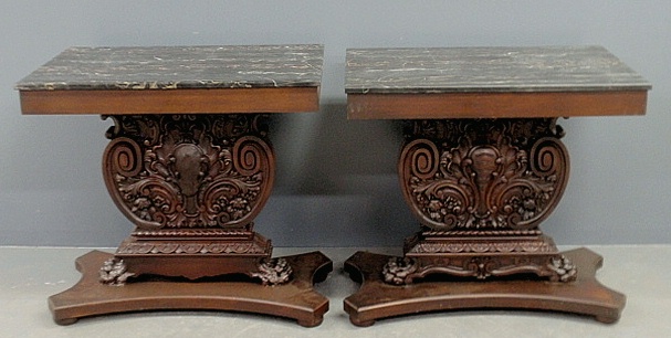 Appraisal: - Pair of ornately carved mahogany console tables with marble