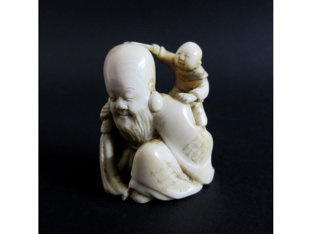 Appraisal: A Japanese carved ivory netsuke of Fukurokujo seated with a