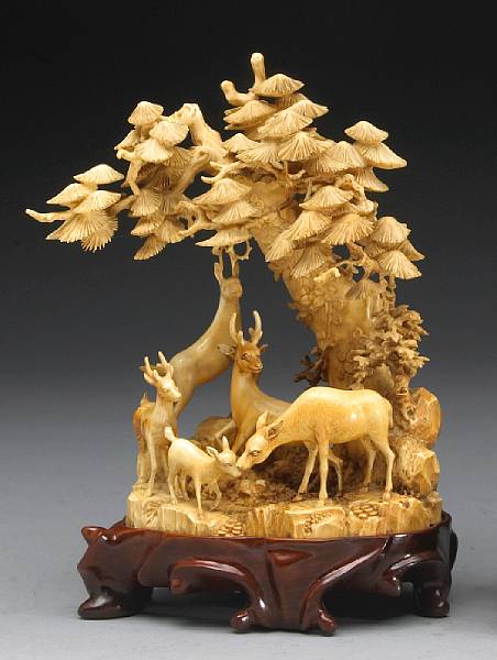 Appraisal: A tinted and carved ivory figural group of deer Naturalistically