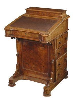 Appraisal: A Victorian walnut Davenport the hinged raised top fitted with