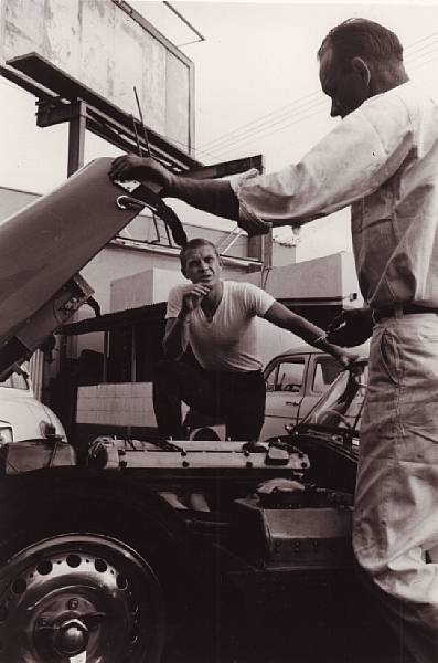 Appraisal: A photograph of Steve McQueen and his Jaguar XK-SS monochrome