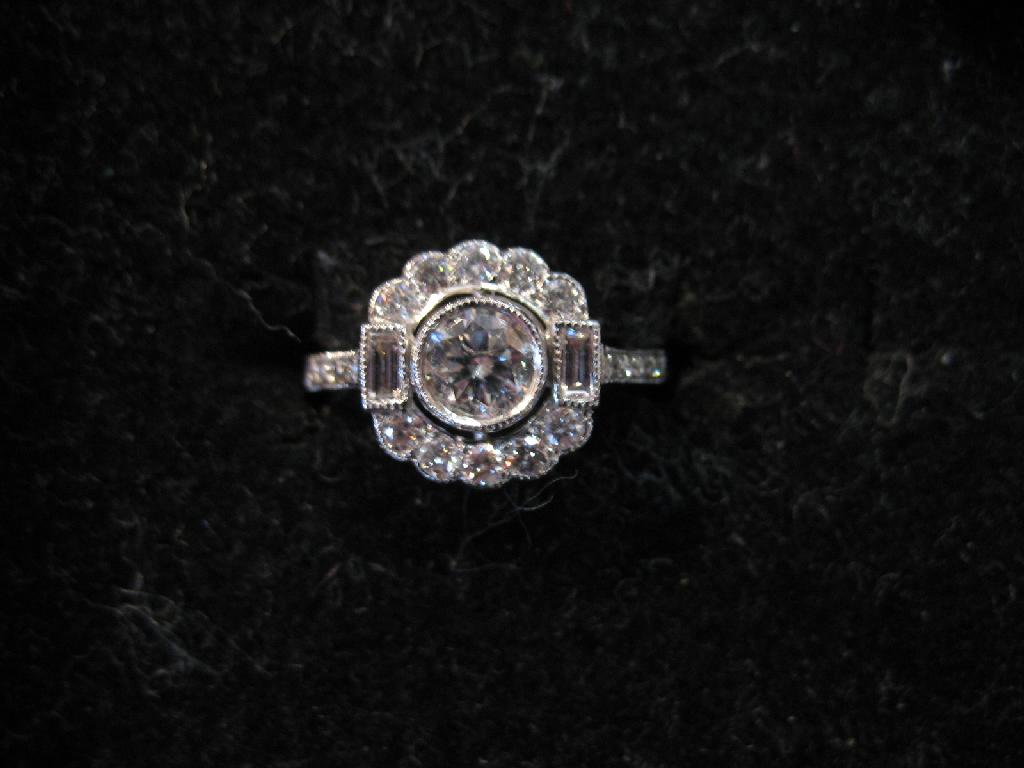 Appraisal: A MODERN DIAMOND DRESS RING the central round brilliant-cut diamond