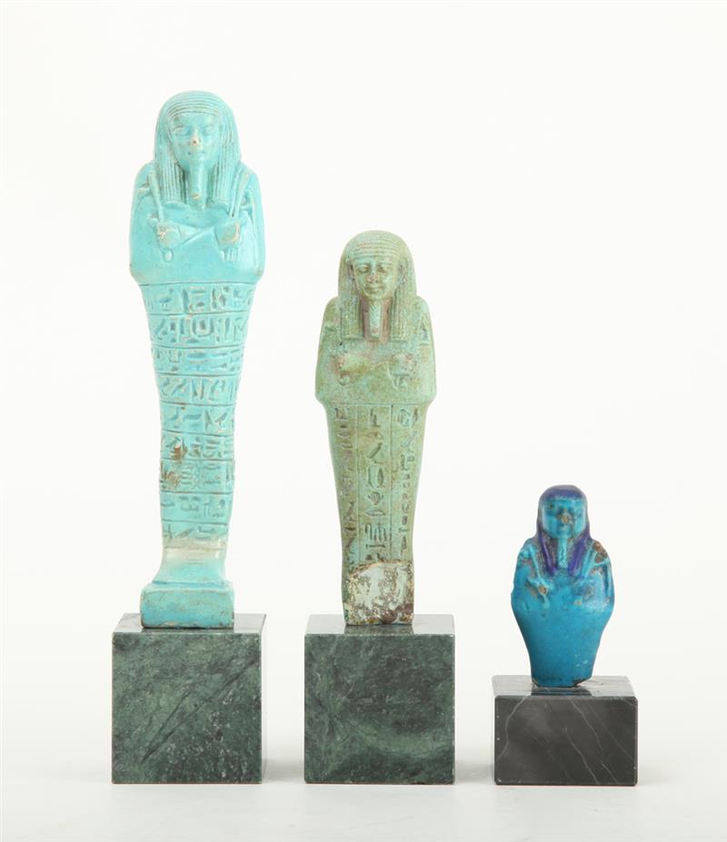 Appraisal: THREE EGYPTIAN TURQUOISE-GLAZED FAIENCE USHABTI Each modeled with tripartite wig