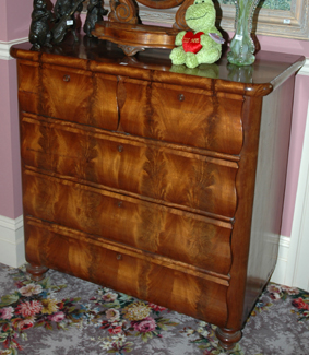 Appraisal: A CONTINENTAL FLAME MAHOGANY CHEST OF DRAWERS The rounded rectangular