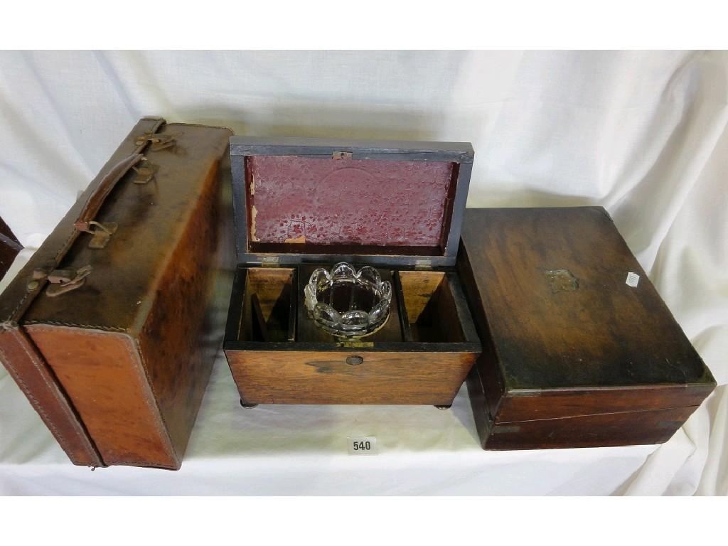 Appraisal: A rosewood sarcophagus shaped tea caddy with glass mixing bowl