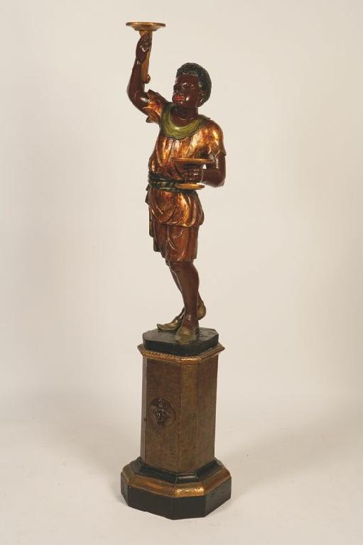 Appraisal: A TH CENTURY BLACKAMOOR FIGURE the boy holding two gilt