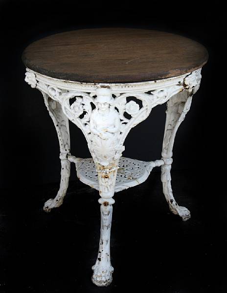 Appraisal: A paint decorated cast iron garden table with wooden top