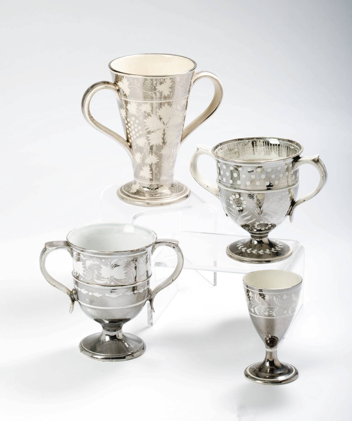 Appraisal: THREE YORKSHIRE AND STAFFORDSHIRE SILVER RESIST LUSTRE LOVING CUPS AND