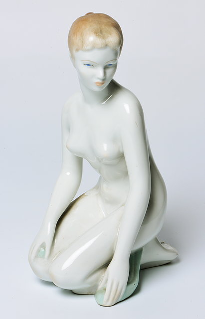 Appraisal: A CONTINENTAL PORCELAIN FIGURE of a kneeling nude young woman