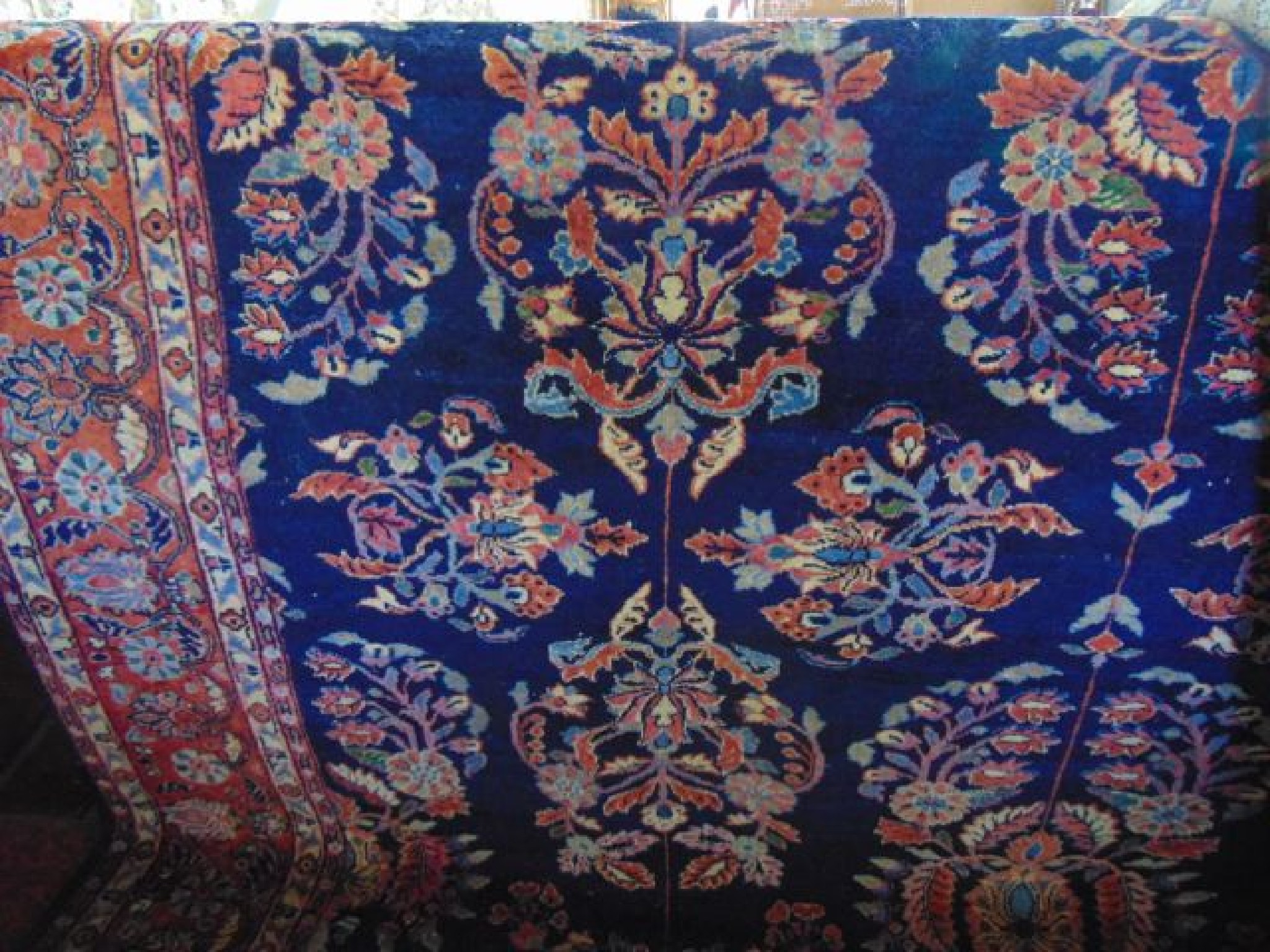 Appraisal: A substantial wool work carpet with deep blue ground decorated