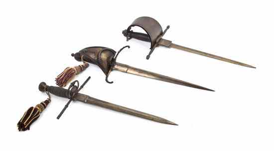 Appraisal: Three Parrying Daggers Weapons two with basket hilts Length of