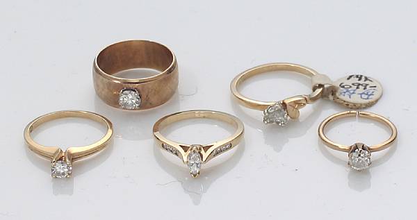 Appraisal: A collection of five diamond and gold rings estimated total