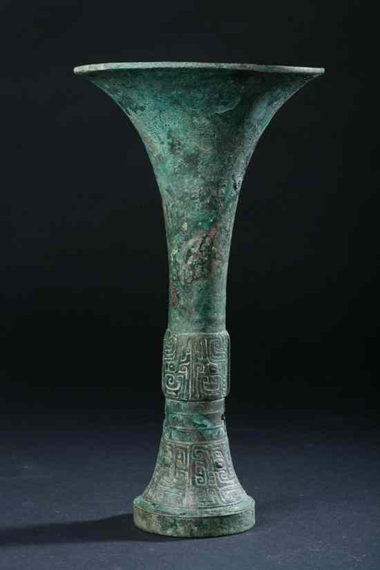 Appraisal: CHINESE ARCHAIC BRONZE RITUAL WINE VESSEL GU Shang Dynasty th