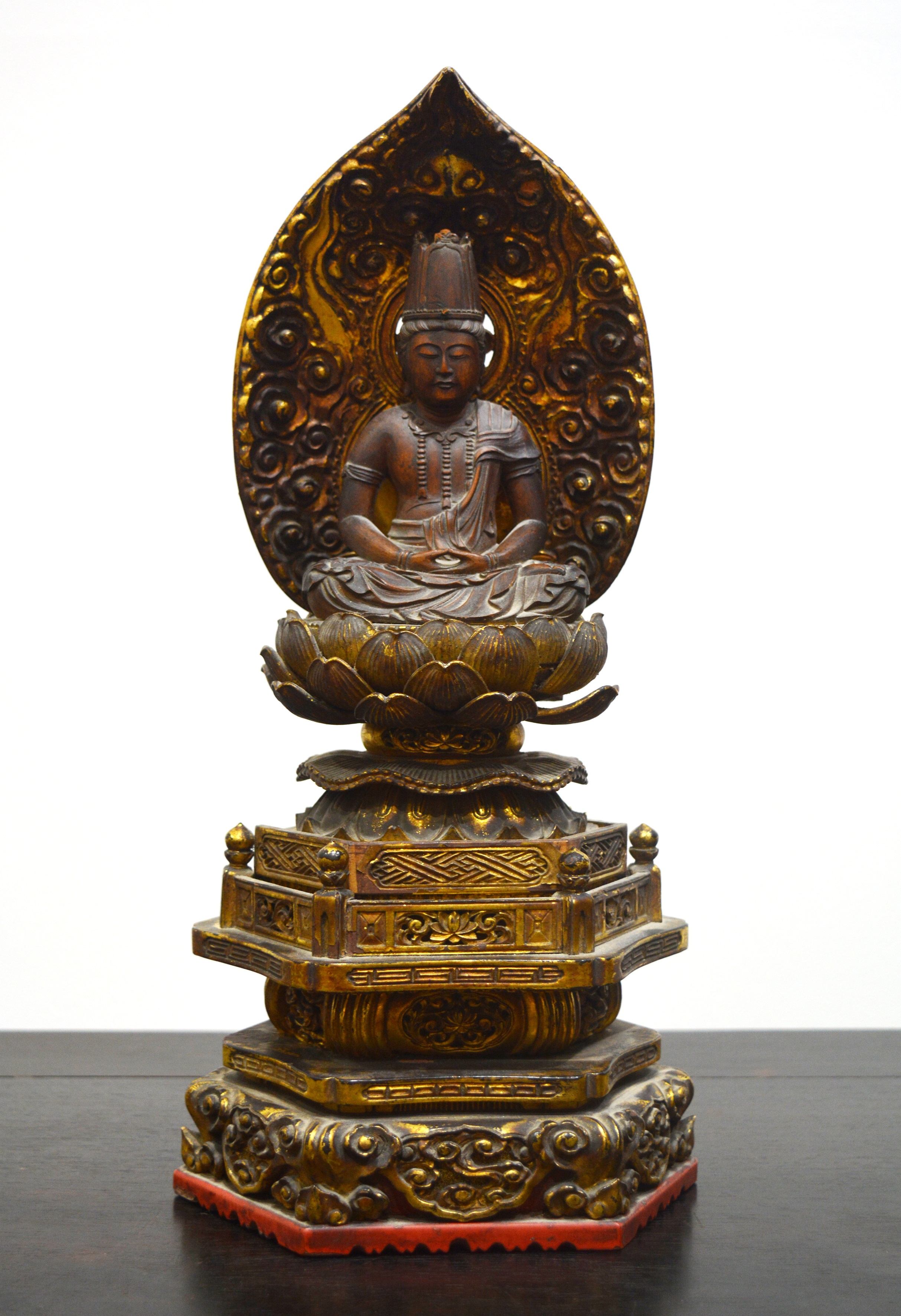 Appraisal: Giltwood buddhaKorean sat on a lotus base perched on an