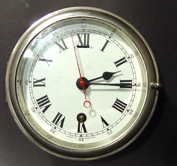 Appraisal: Steel cased ship's clock the enamel dial painted with Roman