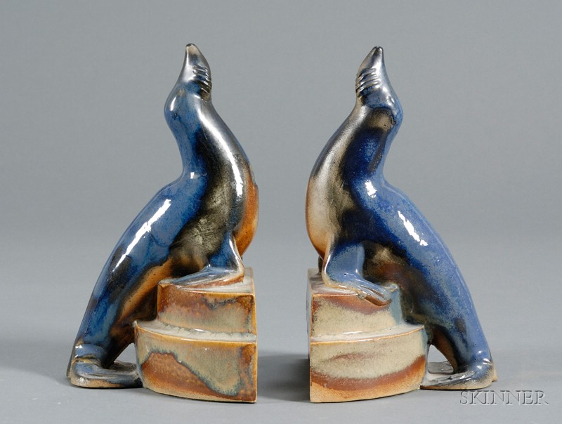 Appraisal: Pair of Blue Glazed Art Pottery Seal Figural Bookends possibly