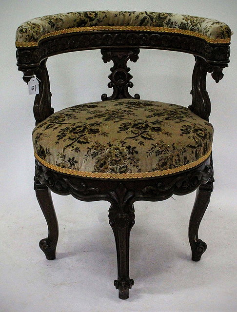 Appraisal: A VICTORIAN CARVED OAK UPHOLSTERED ROTATING DESK CHAIR with upholstered