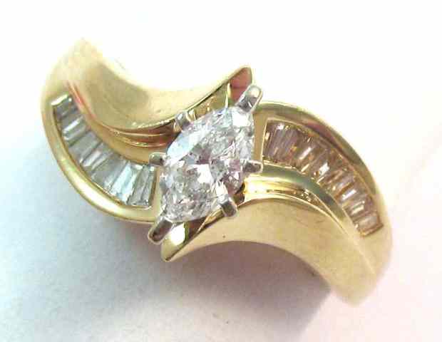 Appraisal: DIAMOND AND FOURTEEN KARAT GOLD RING featuring a marquise-cut diamond