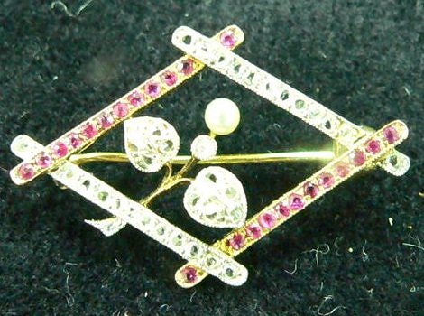 Appraisal: An Edwardian ruby diamond lozenge shaped brooch