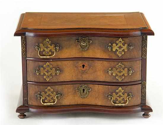 Appraisal: English mixed wood serpentine miniature chest of drawers late th