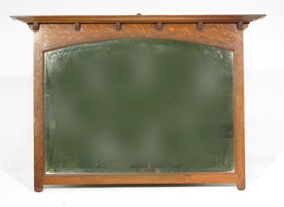 Appraisal: An oak wall mirror with overhanging mantle inlaid with thin