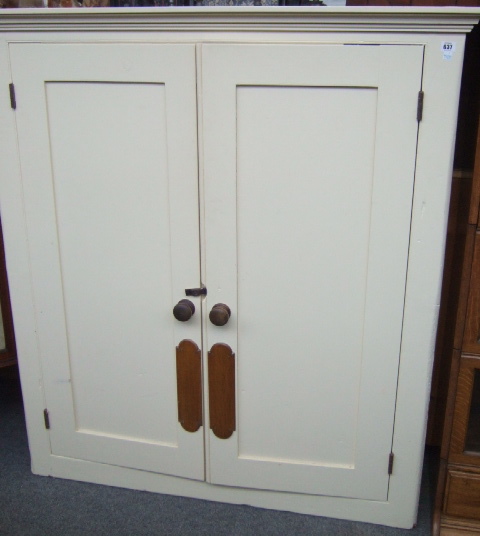 Appraisal: A th century white painted pine cupboard the panel doors