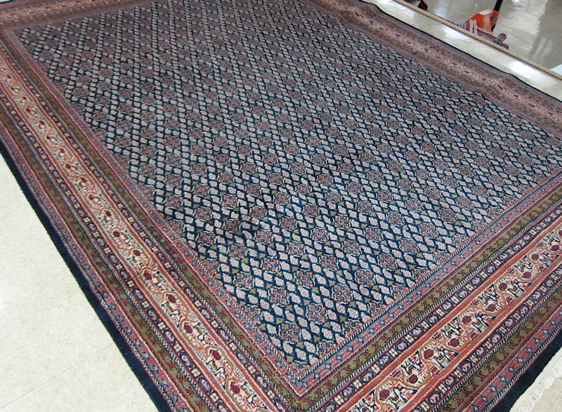 Appraisal: HAND KNOTTED ORIENTAL CARPET Indo-Seraband featuring a dark blue field