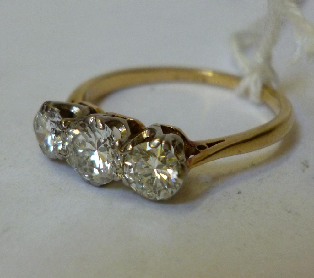 Appraisal: A THREE STONE DIAMOND RING the central brilliant cut stone