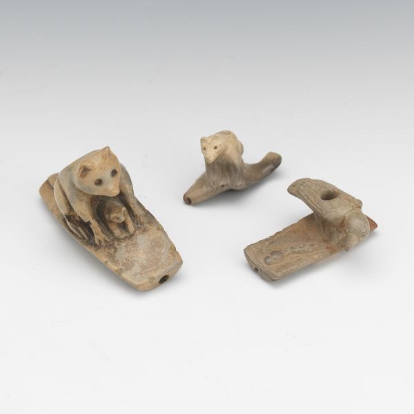 Appraisal: THREE CARVED EFFIGY PIPES Three carved effigy pipes one depicting