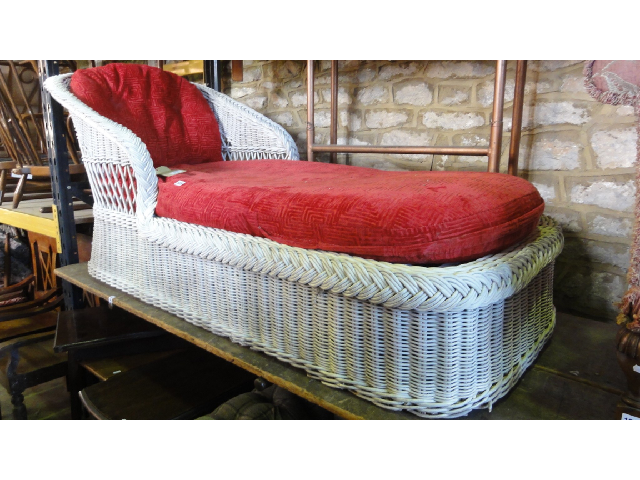 Appraisal: A painted wicker day bed with shaped outline drop in